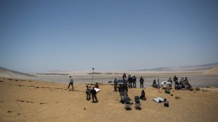 Base camp at the Paracas National Park in Peru. Crew ready to shot with sand and wind.